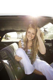 Smiling Caucasian woman sitting in car