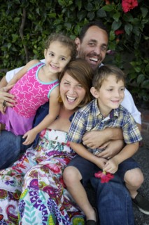 Laughing parents holding children on lap
