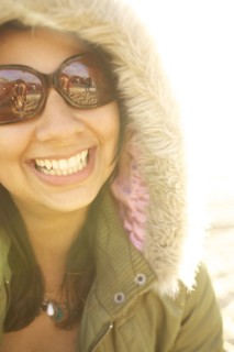 Smiling mixed race woman in fur hood