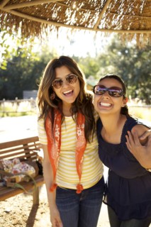 Smiling mixed race sisters hugging
