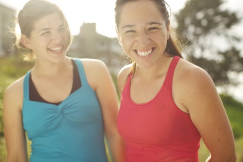 Athletic women smiling together outdoors