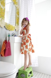 Mixed race girl brushing her teeth