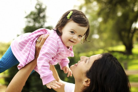 Mother holding toddler daughter