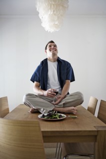 Caucasian man having dinner sitting on table