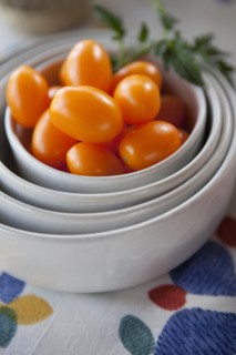 Tomatoes in stack of bowls