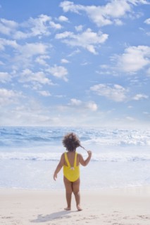 Hispanic girl standing on beach