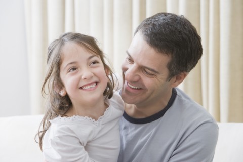 Hispanic father and daughter smiling