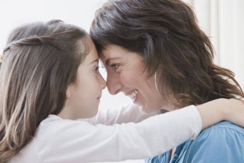 Hispanic mother hugging daughter