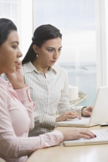 Businesswomen using laptops