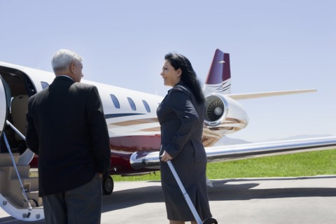 Business people boarding private jet