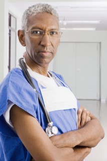 Mixed race surgeon with arms crossed
