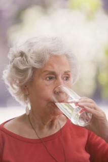 Senior Chilean woman drinking water
