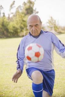 Senior Chilean soccer player bouncing soccer ball