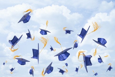 Graduation mortarboards being thrown in the air