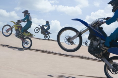Chilean teenagers riding motorcycle on sand dune