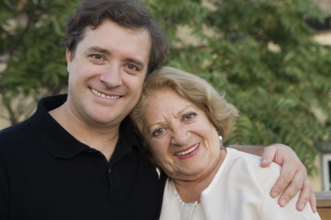 Smiling mother and adult son
