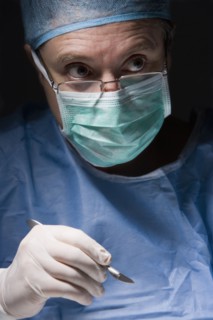 Caucasian surgeon performing surgery