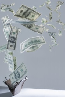 One hundred dollar bills floating out of purse