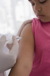 Hispanic doctor giving patient injection in arm