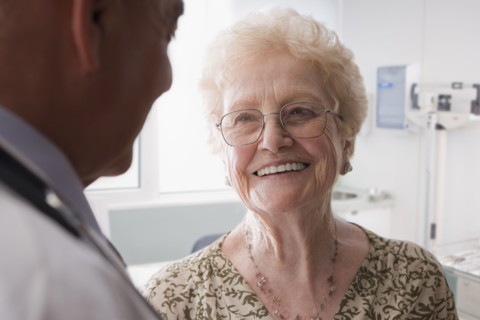 Hispanic doctor talking with older patient