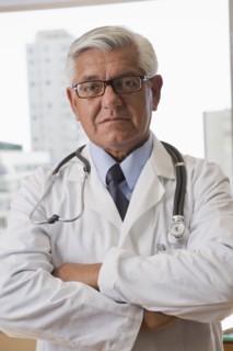 Hispanic doctor standing with arms crossed