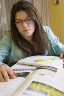 Hispanic girl doing homework at table