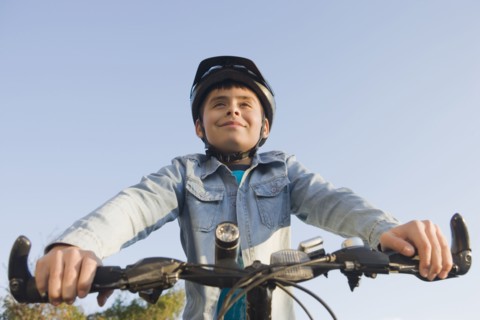 Hispanic boy riding bicycle