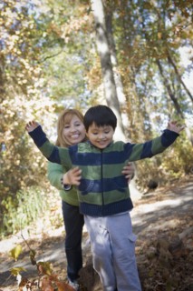 Hispanic mother and son playing in park