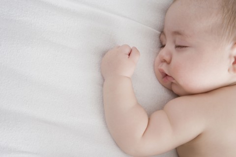 Hispanic baby boy sleeping on bed