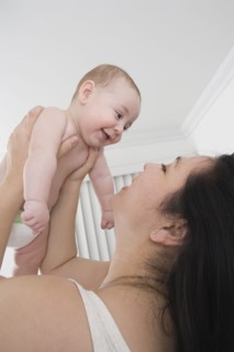 Mother playing with Hispanic baby boy