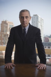Portrait of serious Hispanic businessman in urban office