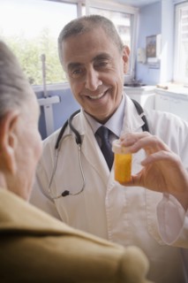 Hispanic doctor giving patient prescription bottle
