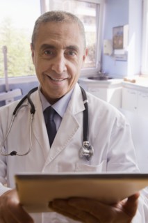 Close up portrait of smiling Hispanic doctor with digital tablet