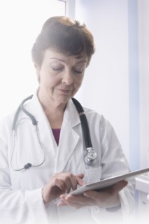 Hispanic doctor using tablet computer in office