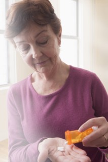 Hispanic woman taking medication