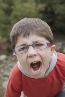 Hispanic boy screaming outdoors