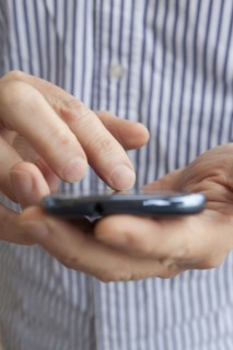 Close up of Hispanic senior man using cell phone