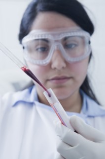 Hispanic scientist pipetting blood sample