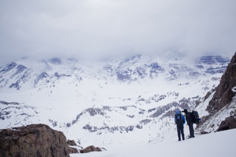 Hispanic hikers admiring snowy scenic mountains