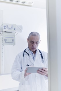 Hispanic doctor using digital tablet in hospital