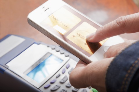 Hispanic woman paying with cell phone