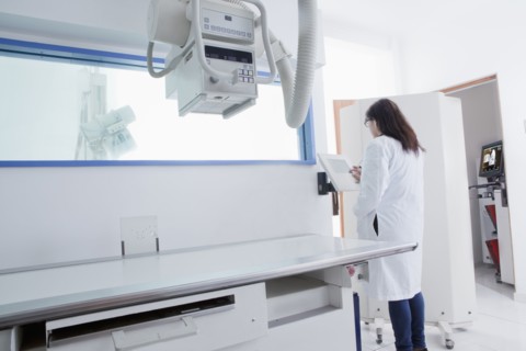 Hispanic doctor using x-ray in hospital