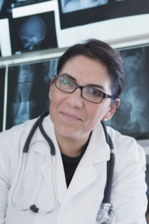 Hispanic doctor smiling in hospital