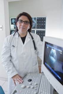 Hispanic doctor examining sonogram in hospital