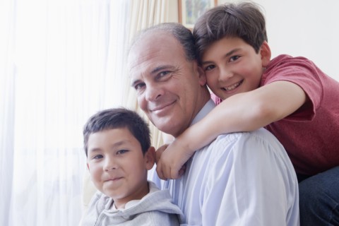 Smiling Hispanic father and sons