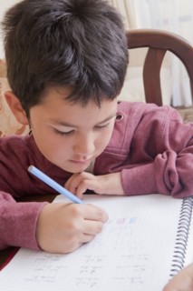 Hispanic boy doing homework at table