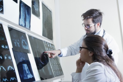 Hispanic doctors examining x-rays