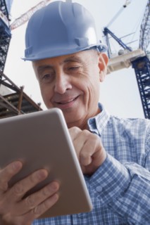 Hispanic construction worker using digital tablet