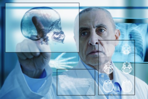 Hispanic doctor using virtual computer screen
