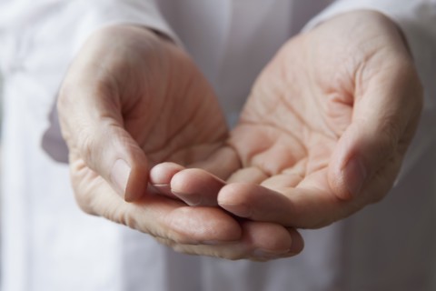 Cupped hands of Hispanic doctor